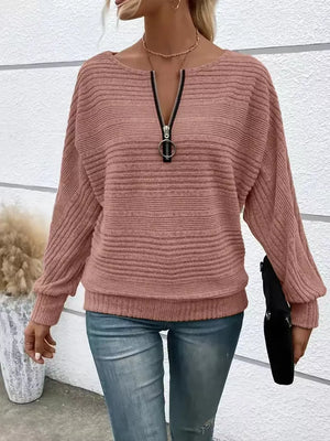 Pink ribbed quarter zip sweatshirt with O-ring pull and dolman sleeves.
