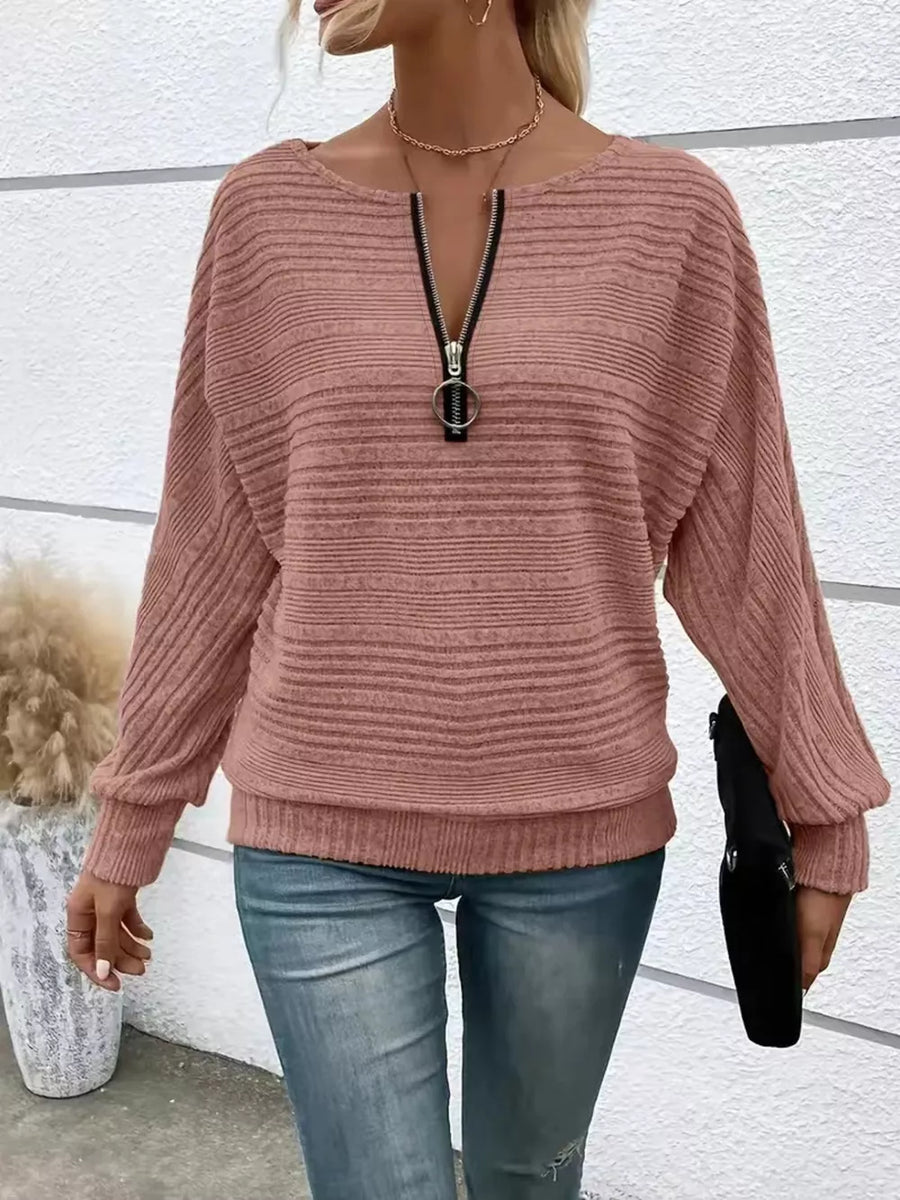 Pink ribbed quarter zip sweatshirt with O-ring pull and dolman sleeves.