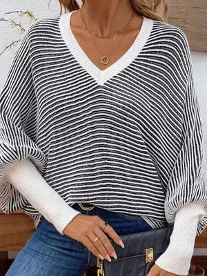 white v-neck sweater featuring ribbed and striped