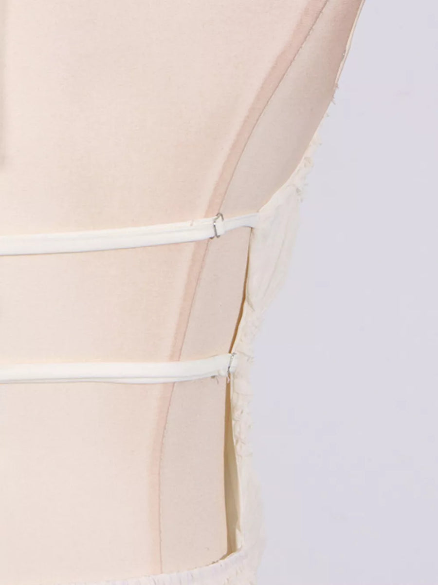 Textured halter neck maxi gown with crisscross back straps in ivory.