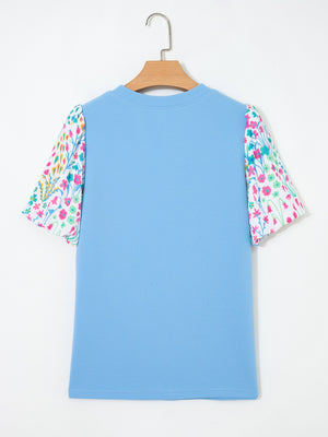 Textured blue blouse with abstract floral bubble sleeves