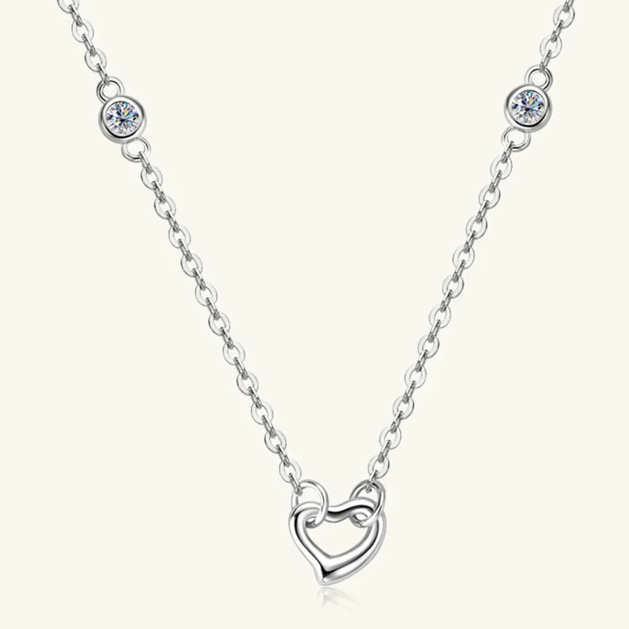 Silver linked heart pendant necklace with bezel-set crystal accents.