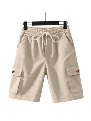 Apricot textured drawstring cargo shorts with button flap pockets.
