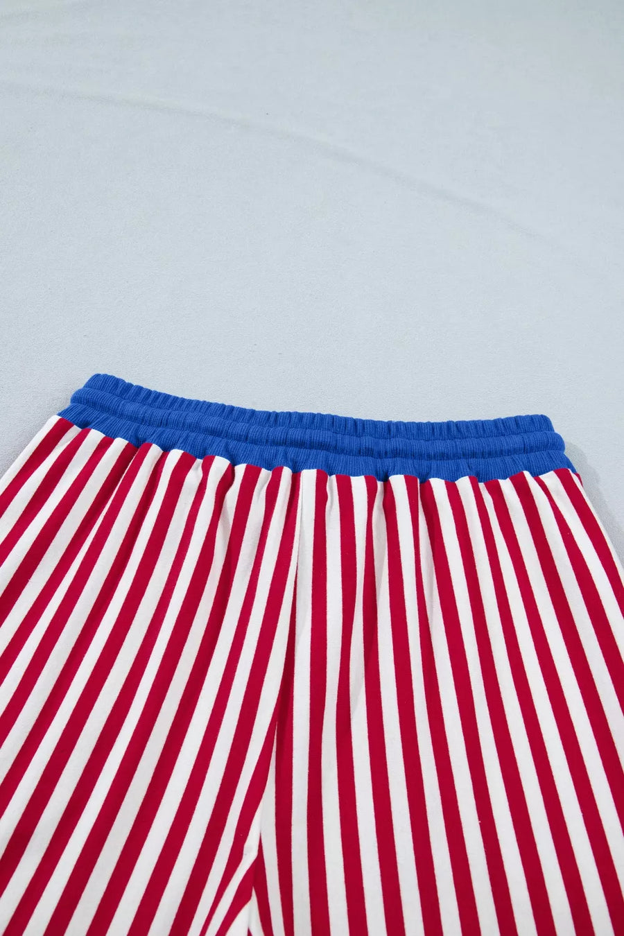 Red and white striped cotton lounge pants with blue drawstring waist