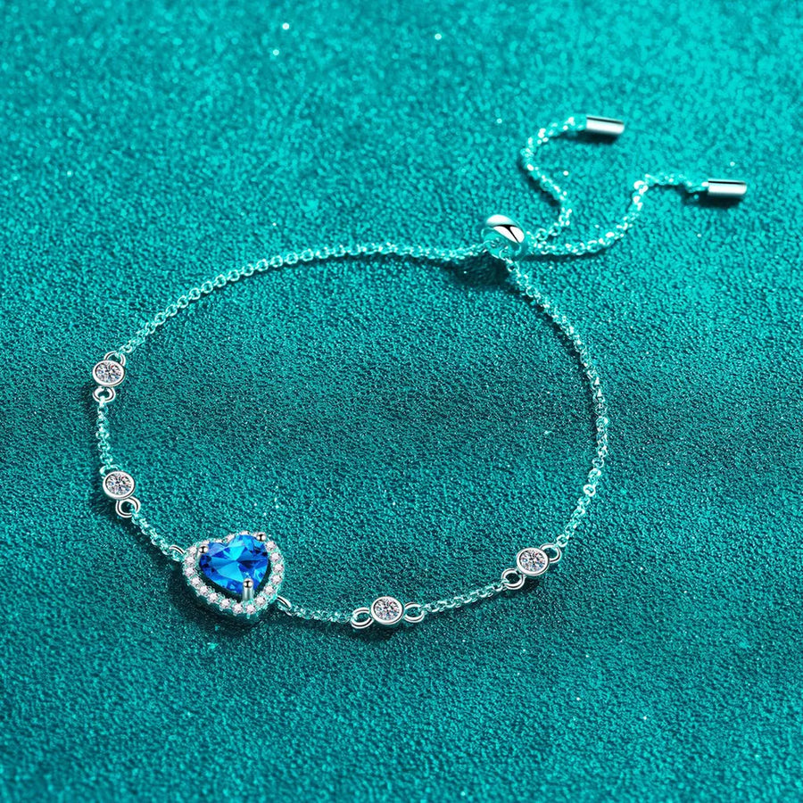 Blue heart halo moissanite adjustable bracelet with clear accent stones.