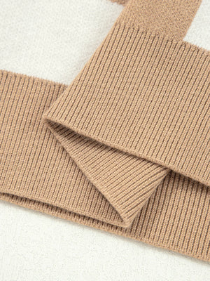 Camel drop shoulder sweater with ribbed knit sleeves and a checkered pattern detail.