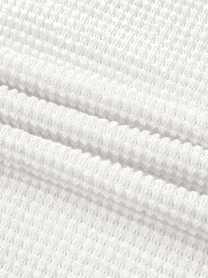 White waffle knit button-up shirt with elastane, showing fabric texture.