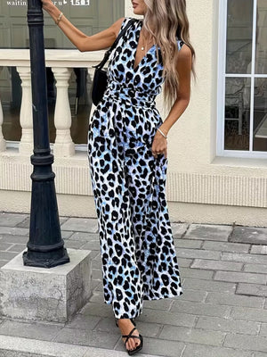 Sleeveless leopard print romper with V-neck and belted waist, in blue and black animal print.
