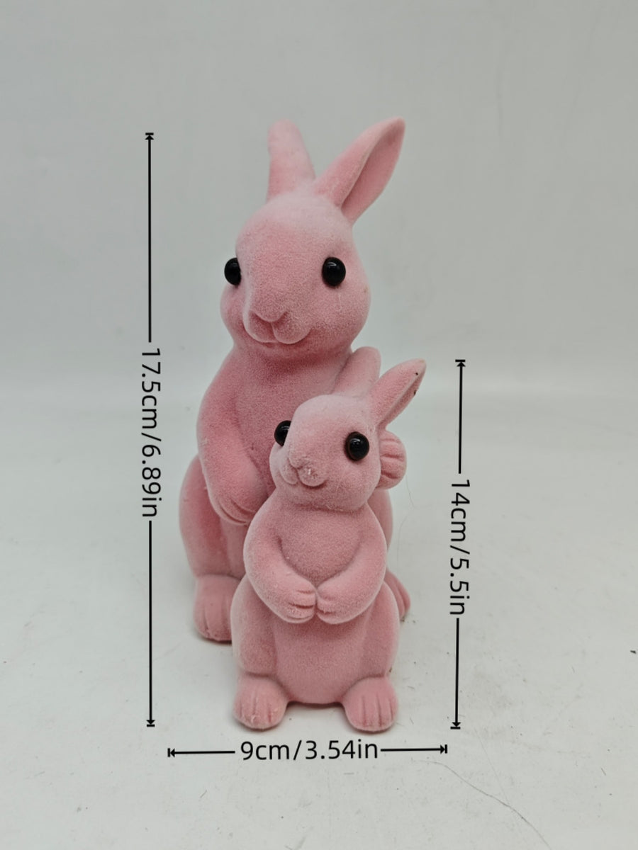 Charming pink flocked bunny decorative ornaments, one large and one small, with black eyes.