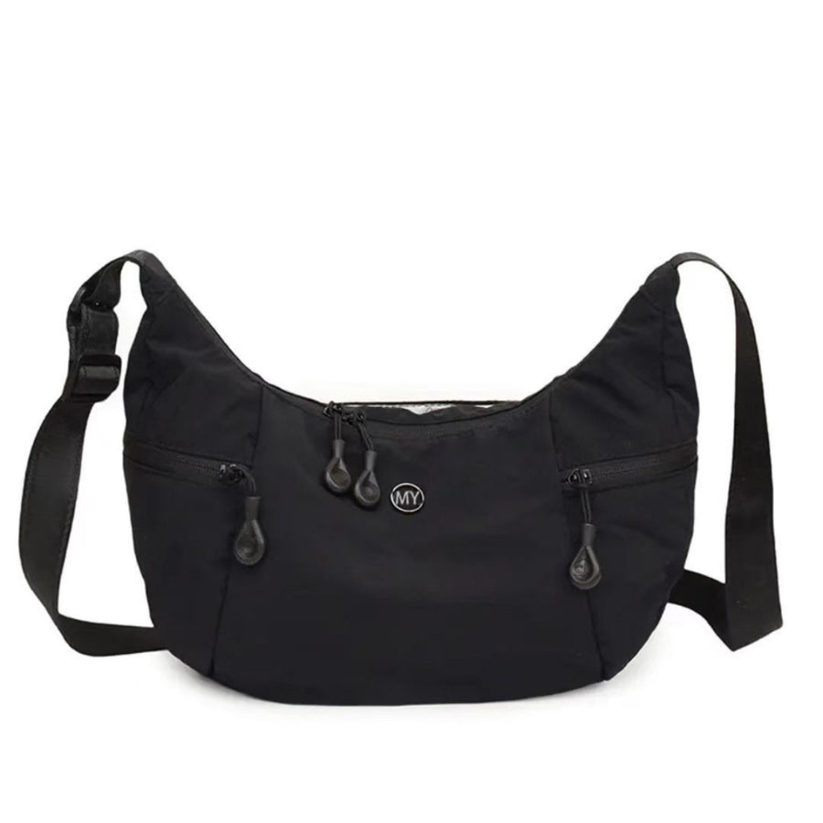 Black nylon crossbody bag with adjustable strap and multiple zippered pockets.