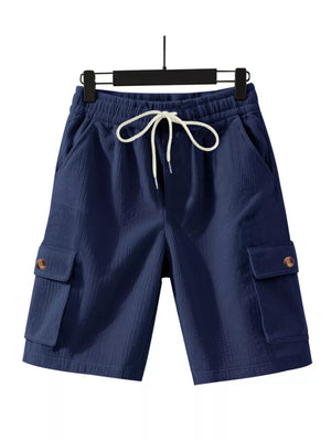 Navy blue textured drawstring cargo shorts with button-flap pockets.