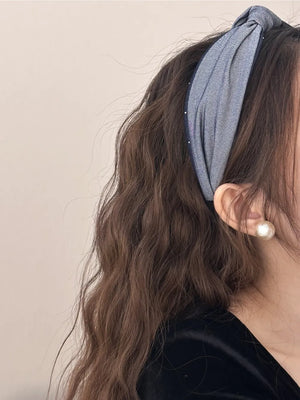 Denim knot headband in medium gray with crystal detail and a twisted knot.