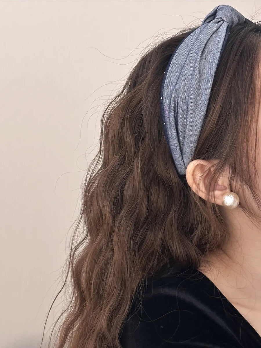 Denim knot headband in medium gray with crystal detail and a twisted knot.