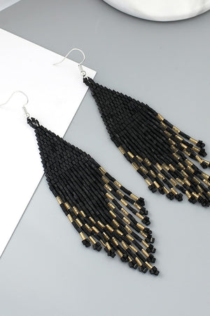Black beaded fringe earrings with gold accents.