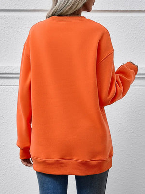 Orange drop shoulder sweatshirt with crew neck and ribbed cuffs and hem.