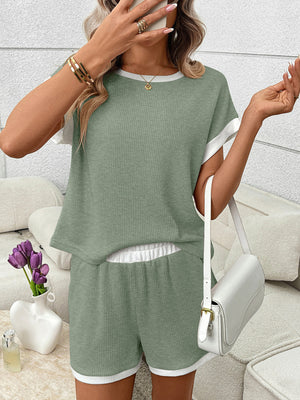 Sage ribbed knit two-piece set with white trim, short sleeves, elastic waistband shorts and pockets.