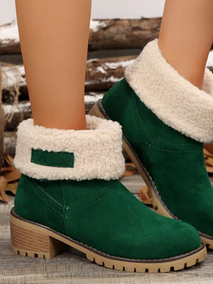 Green suede ankle boots with sherpa trim and block heel.