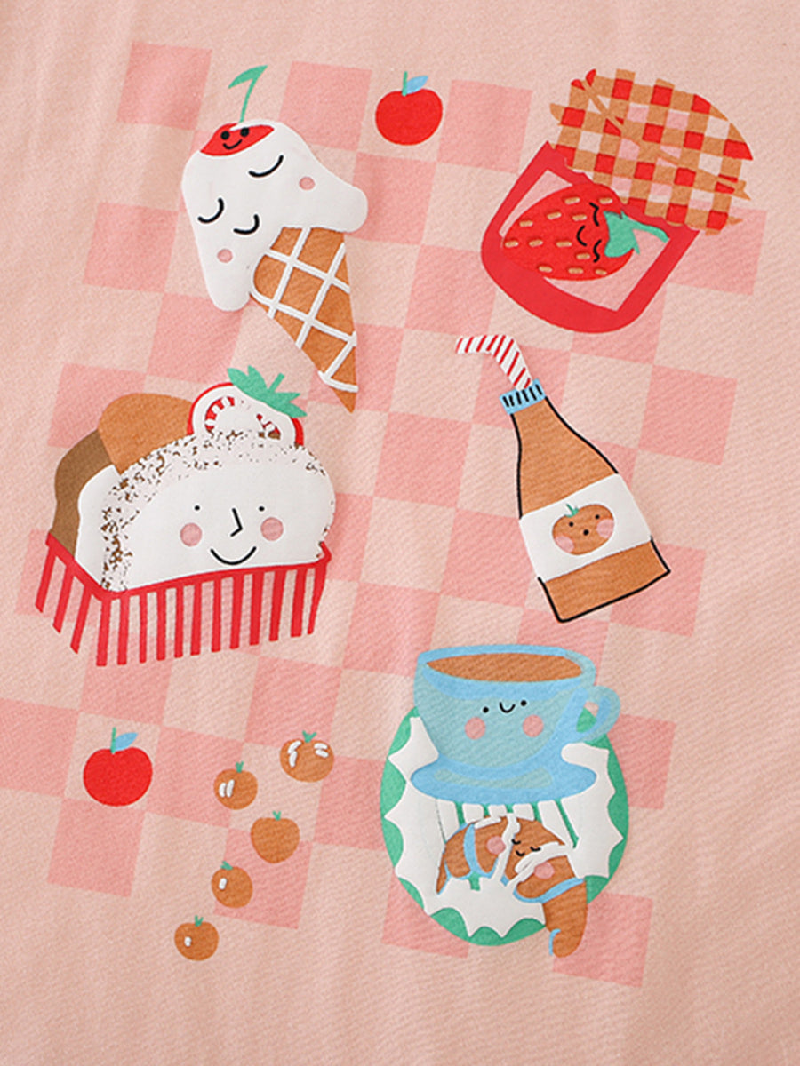 Toddler graphic tee with ice cream, cupcake, and fruit graphics on pink checkered cotton.