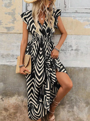 Black geometric ruffled midi dress with V-neck, smocked waist, and thigh slit.