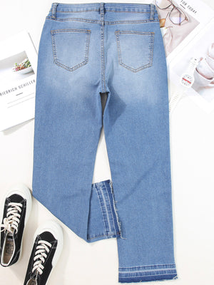 Whiskered wash cropped jeans in light blue denim with frayed hem detail.