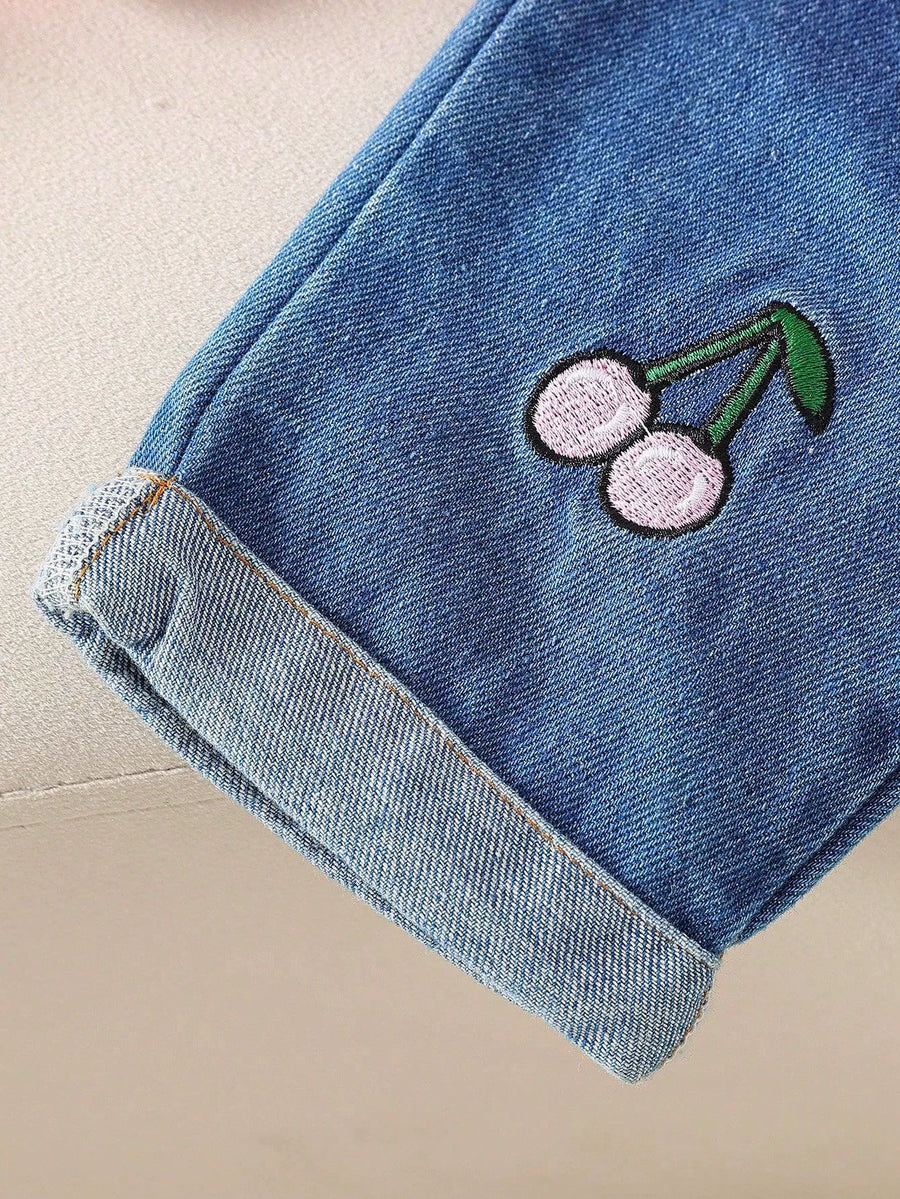 Baby denim set with embroidered cherries and cuffed hem.