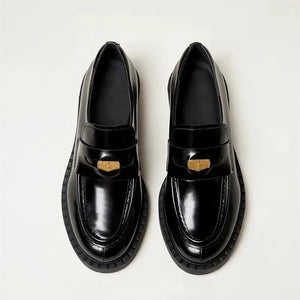 Black patent leather loafers with gold hardware detail and chunky sole.