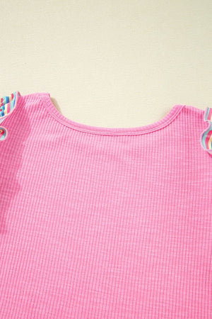 Pink ribbed knit top with pastel stripe sleeve detail