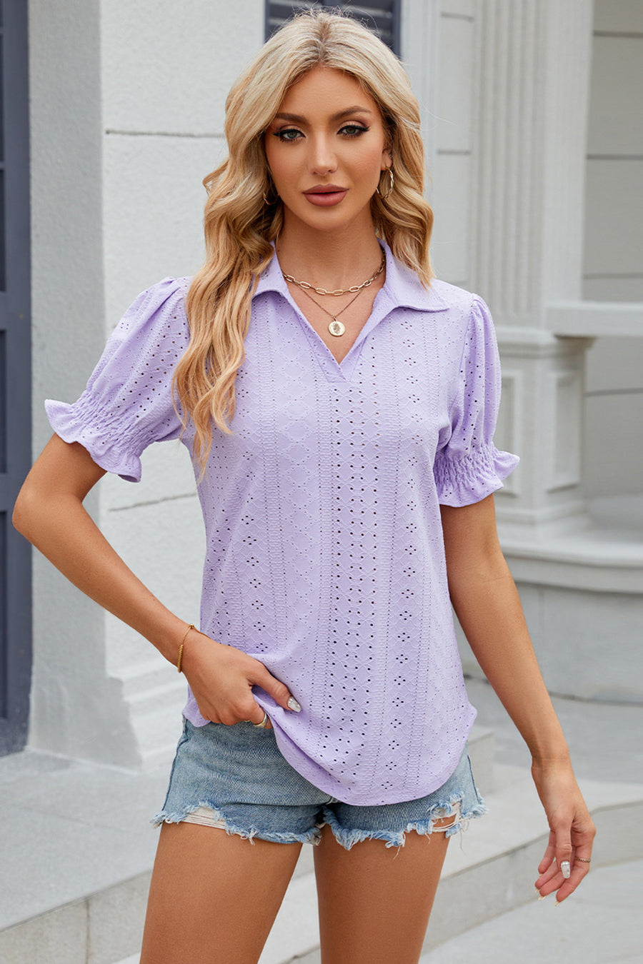 Lavender eyelet polo blouse with short puff sleeves and ruffled cuffs.
