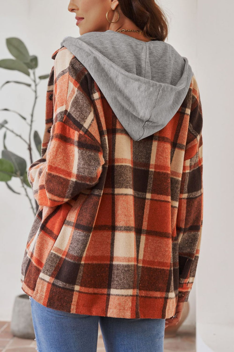 Plaid hooded shacket in orange, tan, and brown with a relaxed fit.