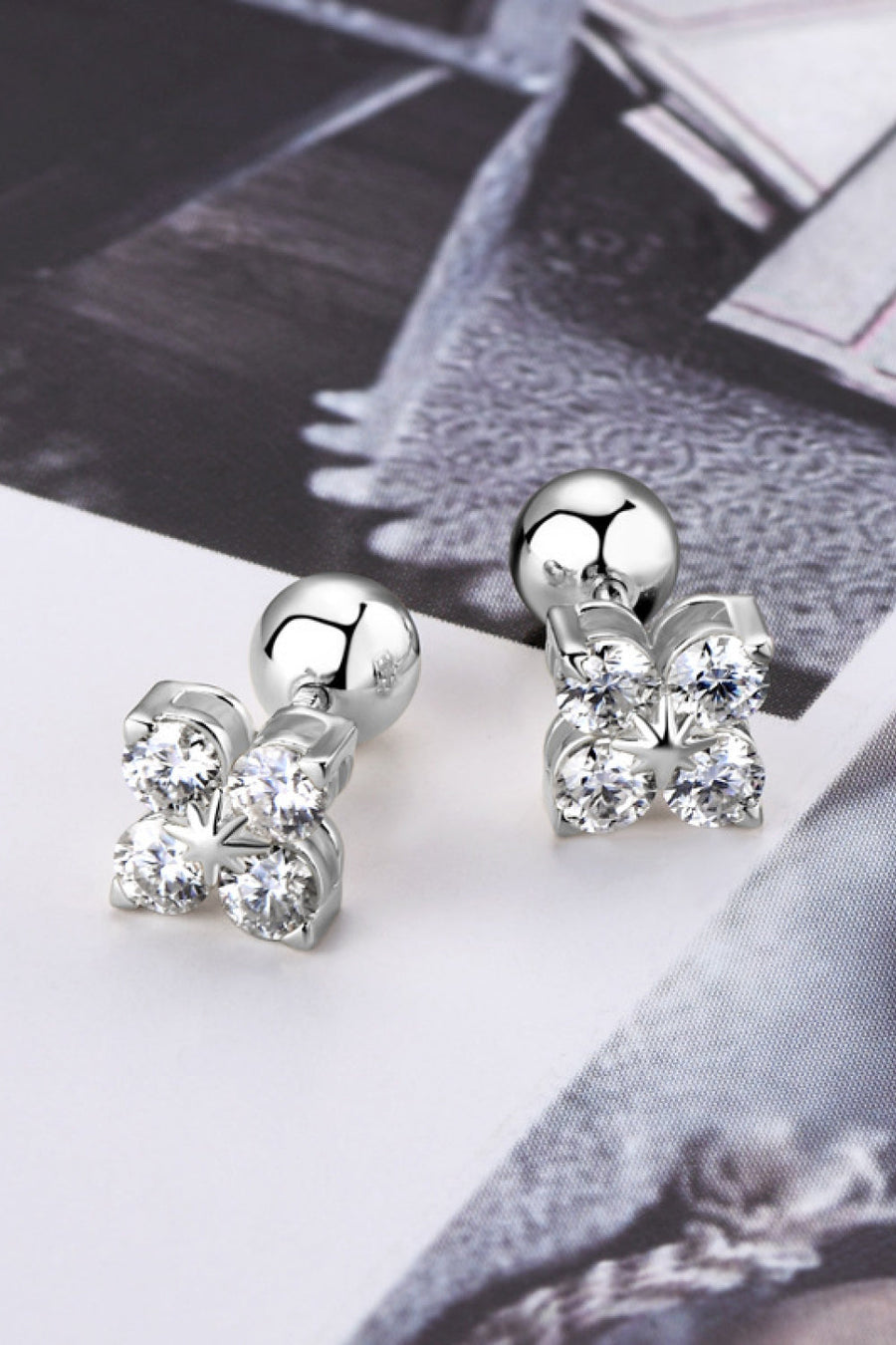 Silver stud earrings with four clear stones in a flower design, sterling silver.