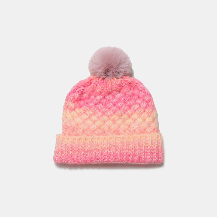 Textured ombre knit beanie in pink and yellow with a pom pom.
