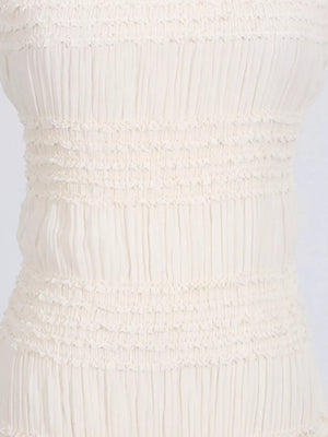Textured halter neck maxi gown in ivory with smocked bodice detail.