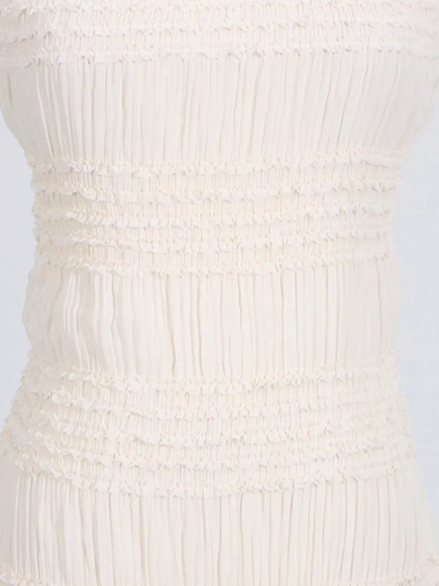Textured halter neck maxi gown in ivory with smocked bodice detail.
