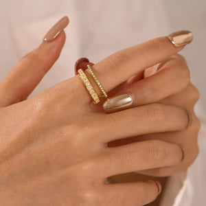 Opulent gold-plated open ring with dual bands and baguette rhinestones.