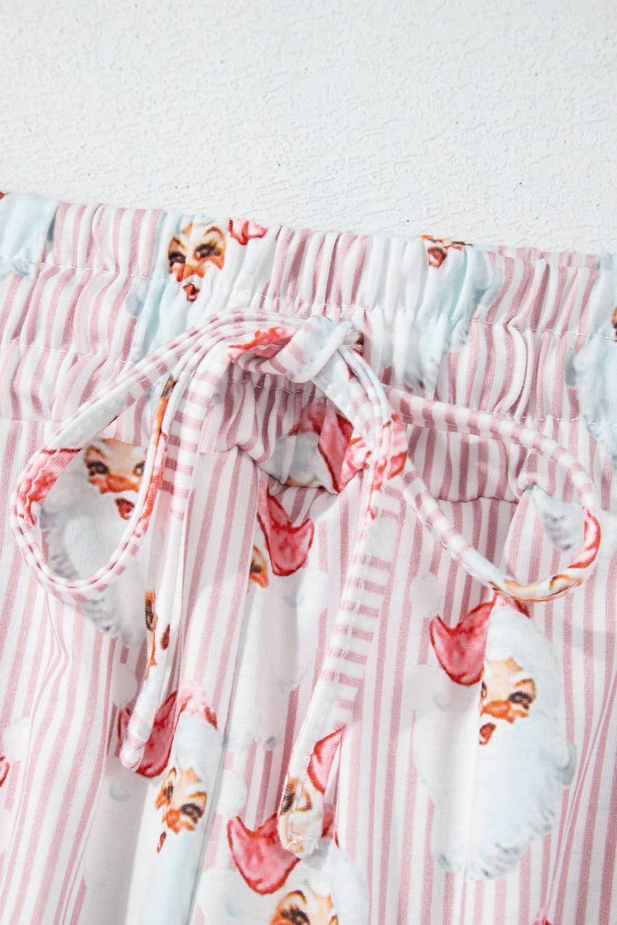 Loungewear set with pink stripes and Santa print, featuring a drawstring waist.