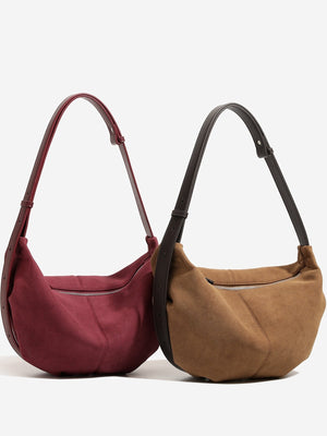 shoulder bag in burgundy featuring adjustable straps and crescent fit