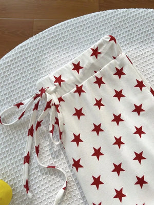 red pants featuring drawstring waist and star-print