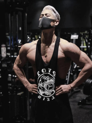Black graphic muscle tank with racerback and dinosaur print.