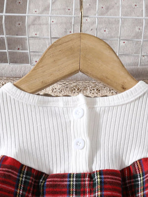 Baby girls' white ribbed top with burgundy plaid skirt and button detail.