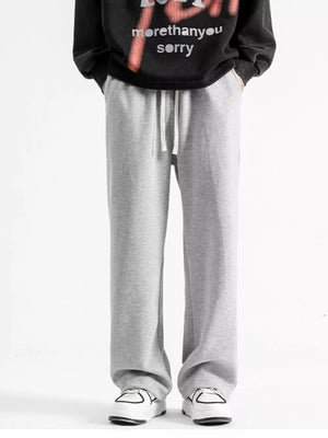 Light gray cotton sweatpants with drawstring and wide legs.