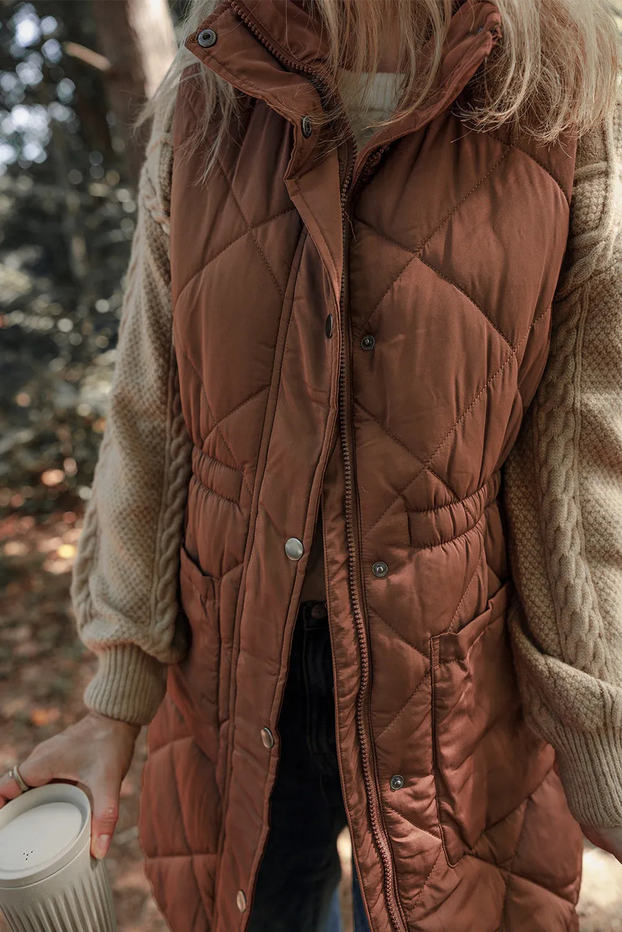 Brown diamond quilted longline vest with cinched waist detail and pockets