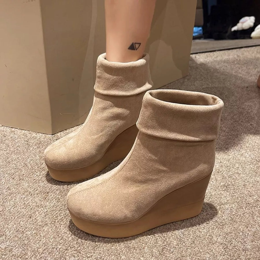 Apricot suede wedge boots with folded cuffs and platform sole.