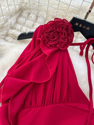 Red one-shoulder maxi dress with floral accent and ruffle details.