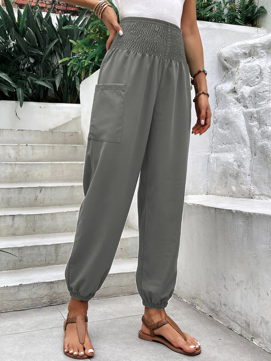 Gray relaxed-fit cargo pants with smocked waistline and elastic cuffs.