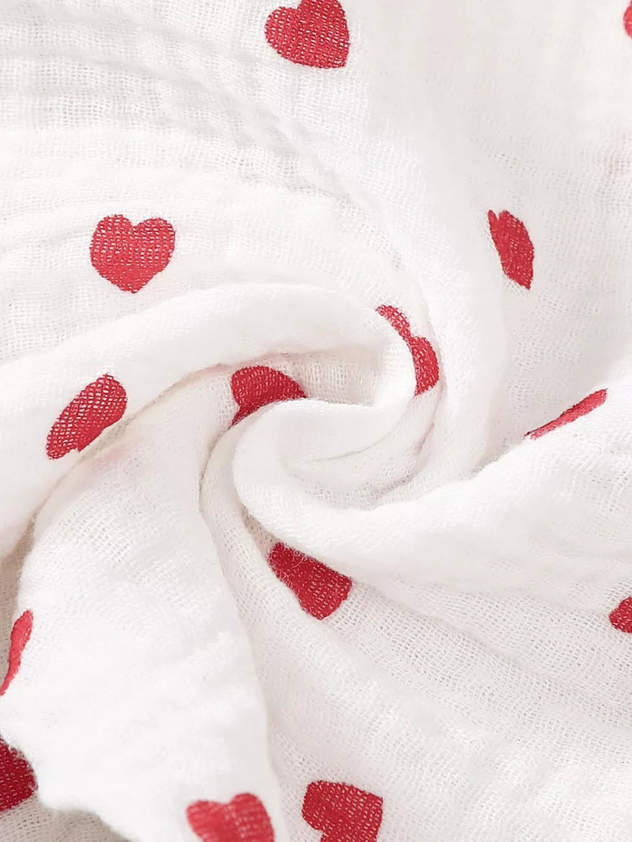White cotton baby outfit with red heart print and headband detail