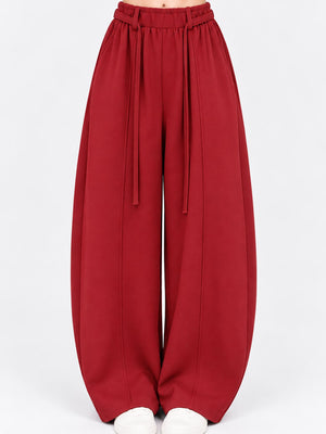 wide-leg pants in burgundy featuring adjustable and loose fit