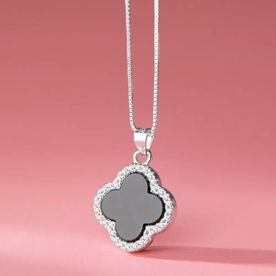 silver necklace featuring clover pendant and clover