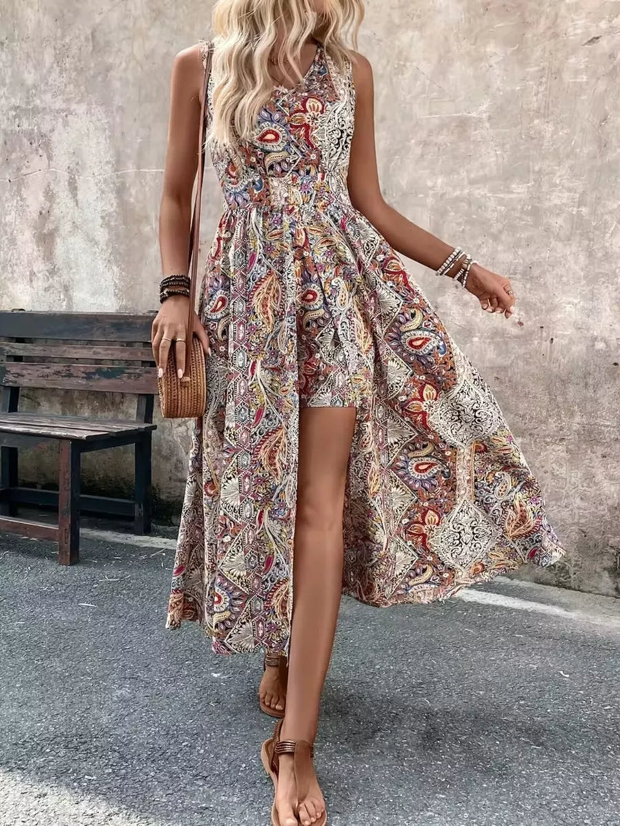 Vibrant paisley print overlay romper with cinched waist and dramatic slit.