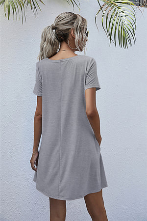 Light gray relaxed pocketed tee dress with short sleeves and crew neck.