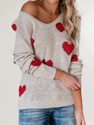 red v-neck sweater featuring ribbed cuffs and heart-print